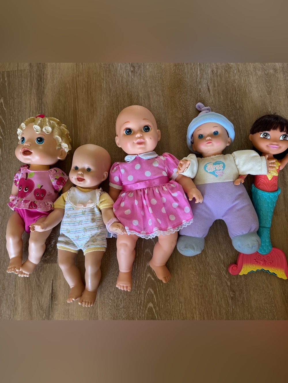 4 baby doll and Dora mermaid doll